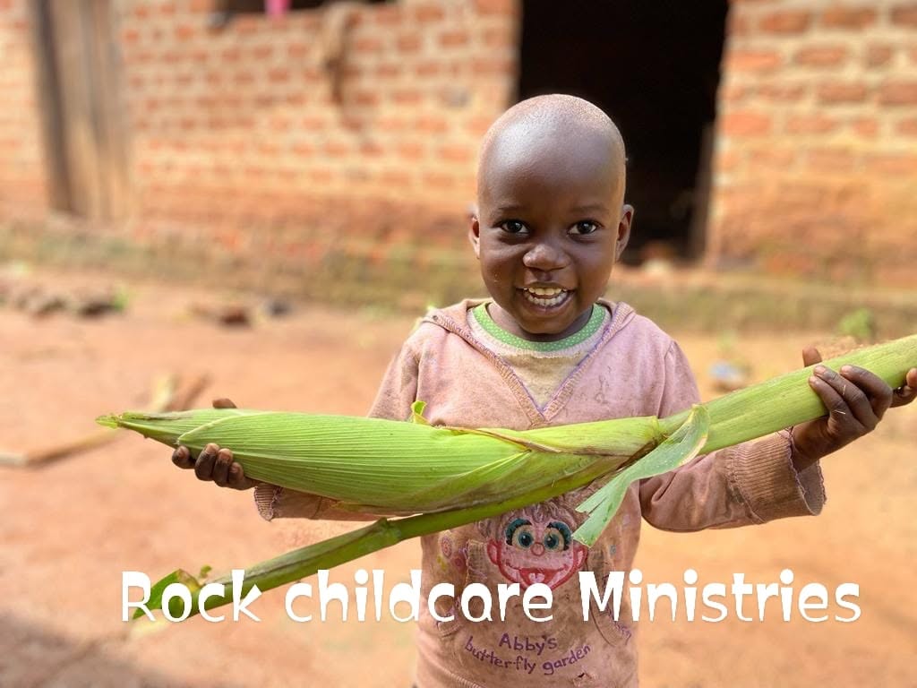 Child smiling with corn